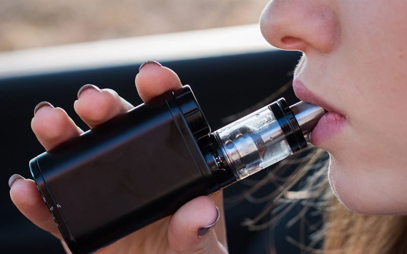 Woman Vaping behind the wheel