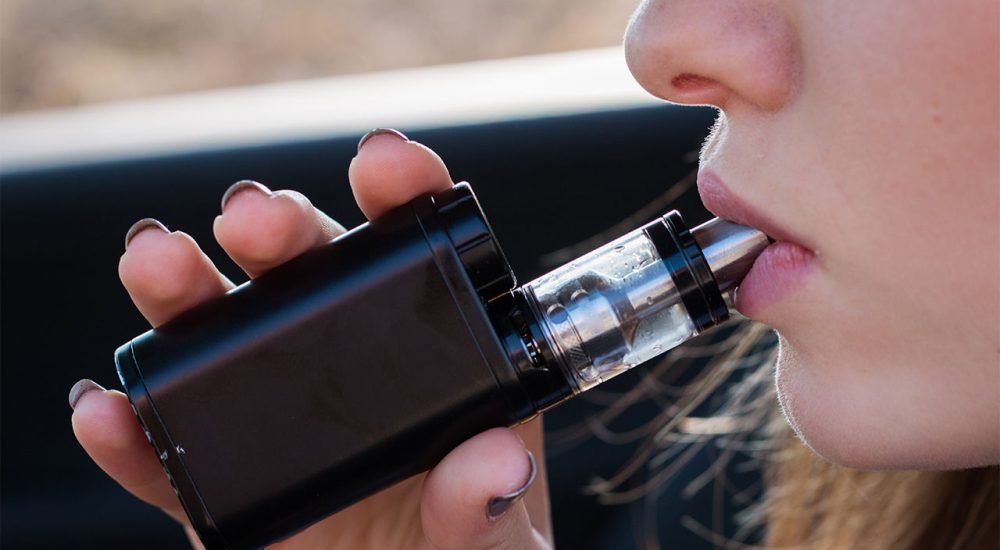 Woman Vaping behind the wheel